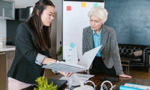 Two women looking at paperwork in an office